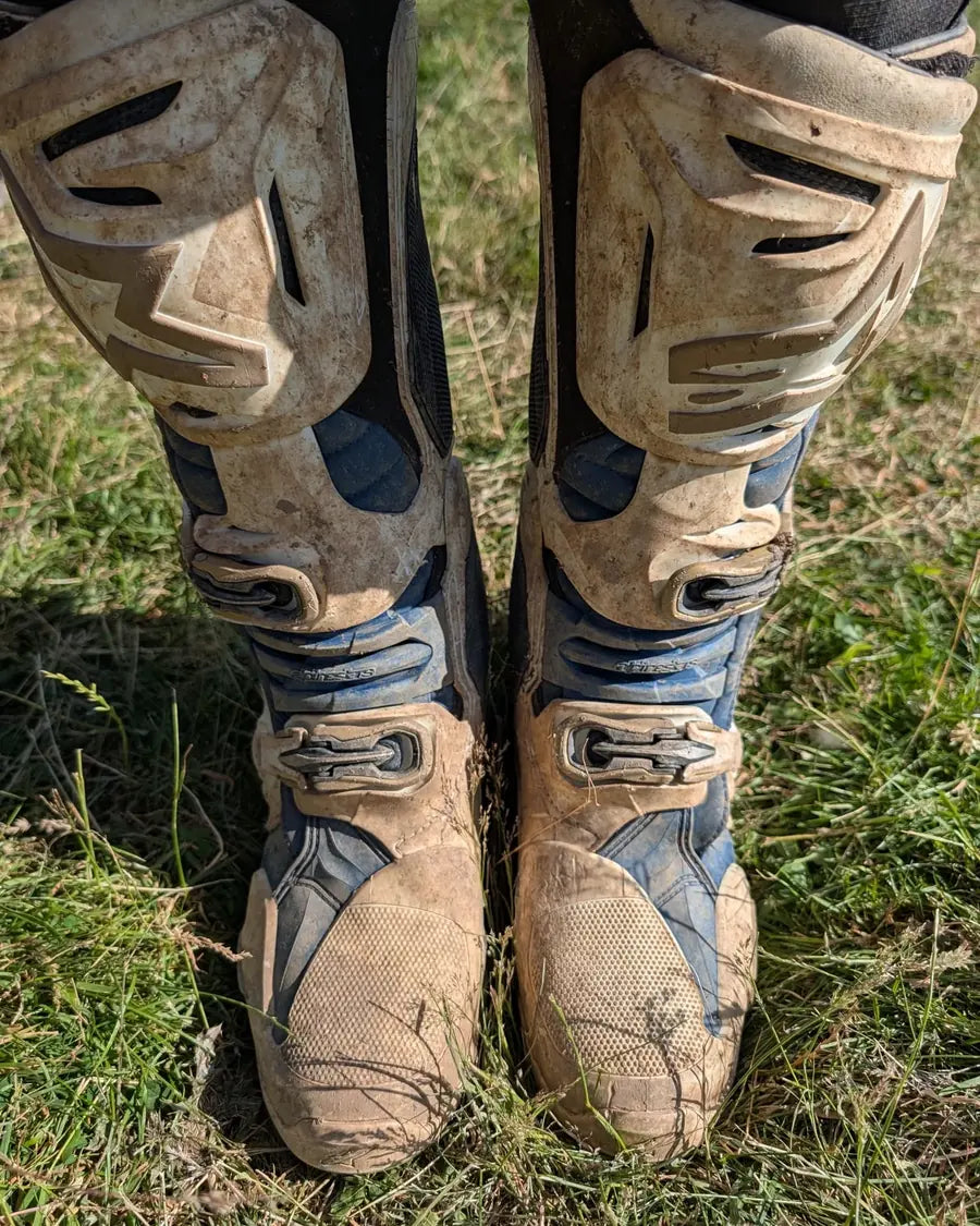 Dirty white motocross boots before cleaning